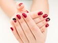 Closeup photo of a beautiful female hands with red nails on white background