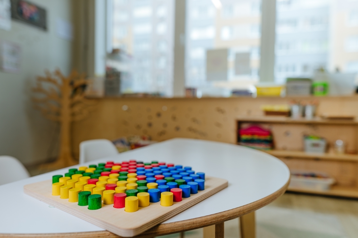 Wooden mosaic on the table in kindergarten. Great for developing imagination and creativity. Educational toys from natural materials concept. Selective focus. (Wooden mosaic on the table in kindergarten. Great for developing imagination and creativity