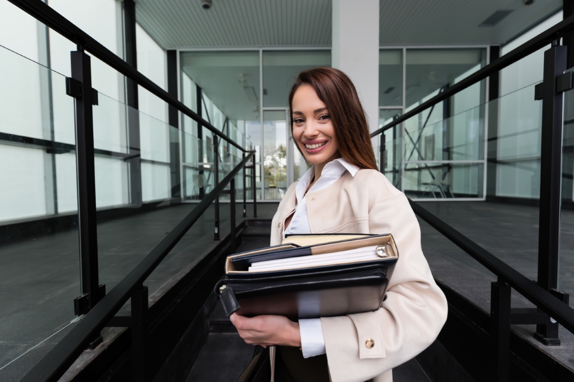 Attractive and beautiful businesswoman smiling and standing in office