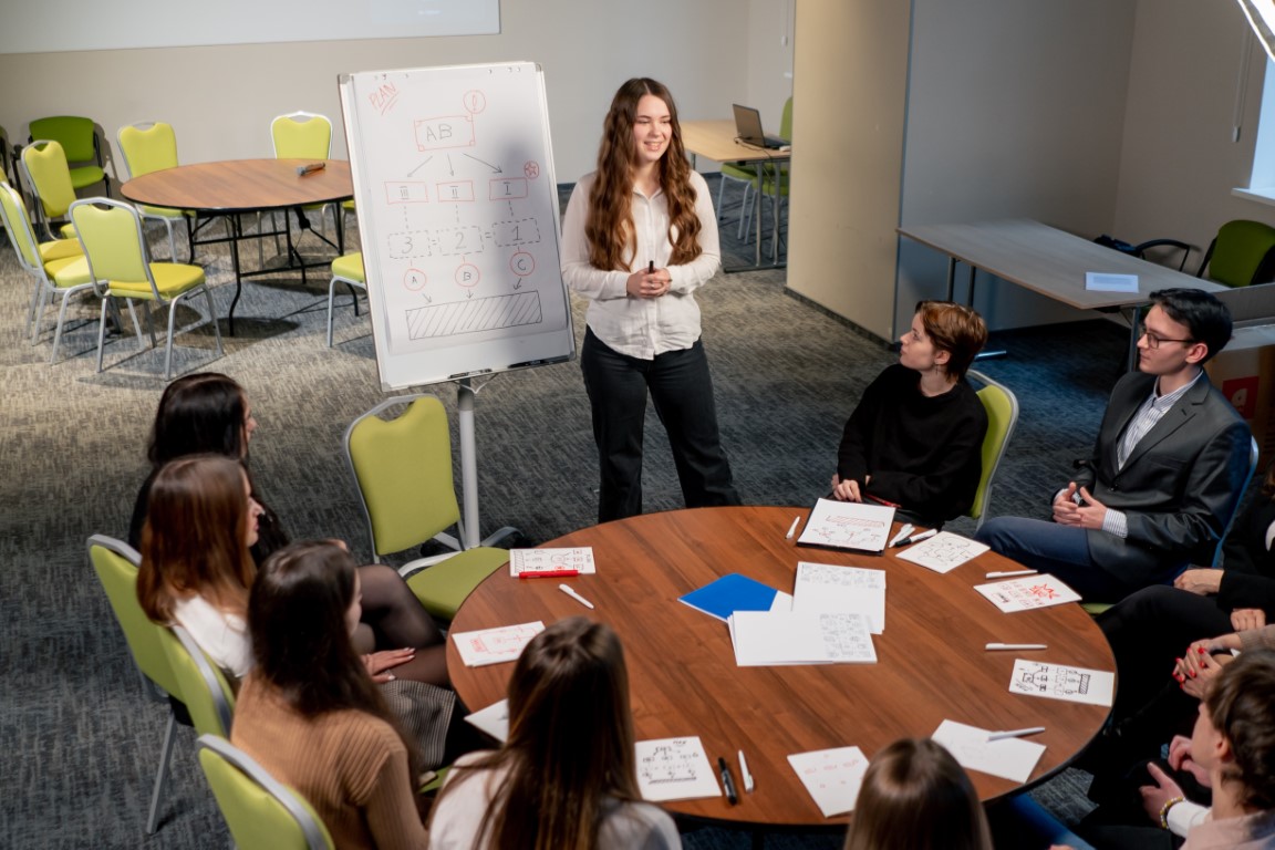 business conference or meeting at the hotel the girl on the flipchart shows the development plan for company